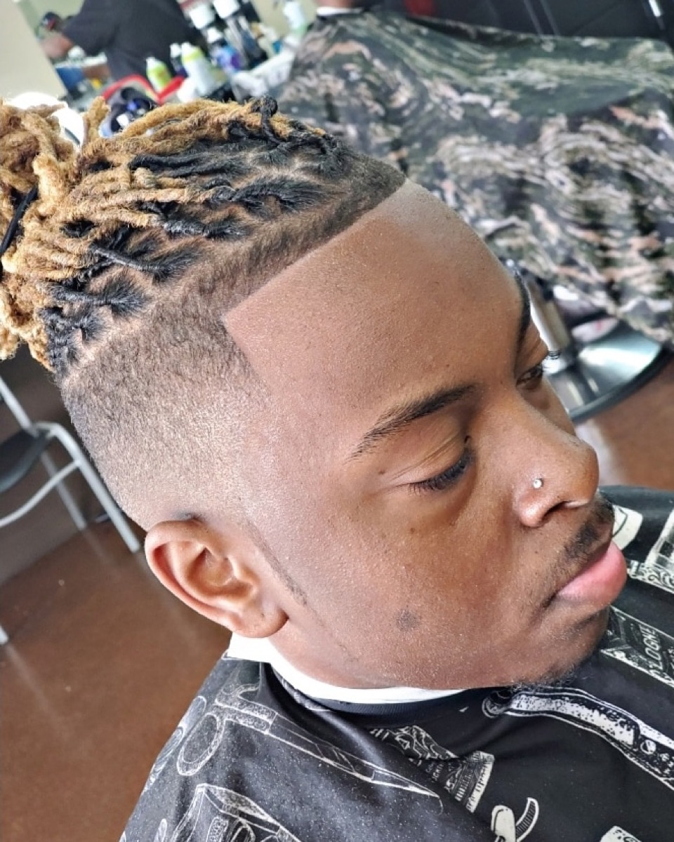 Sharp high-top with a clean skin fade and crisp line-up at Brown's Barber Lounge in Stockbridge, GA