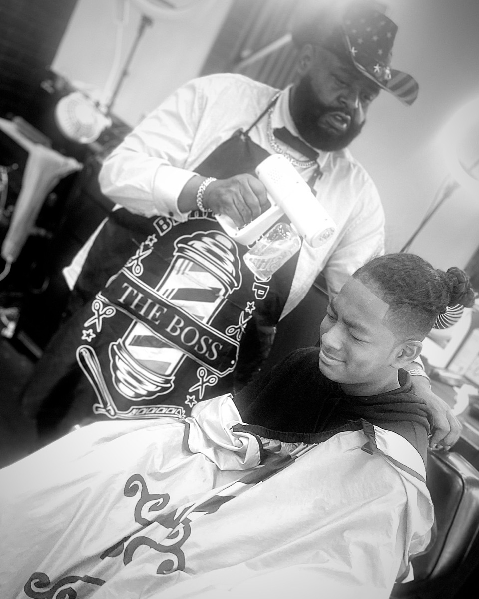 A young client getting a fresh cut — patient, friendly kids' service